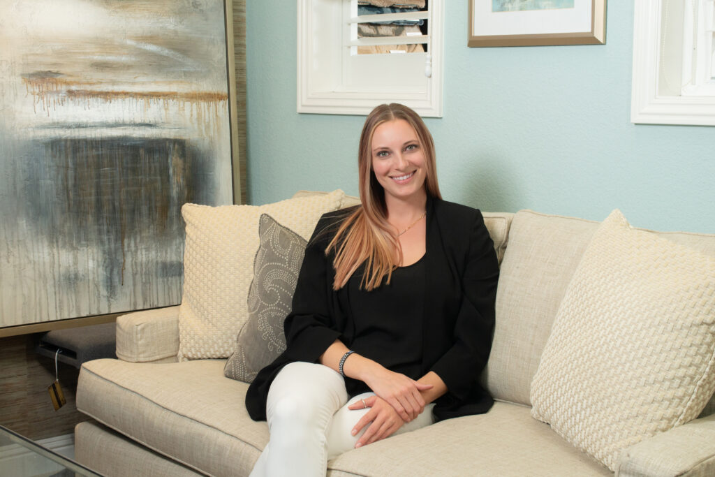 Kelsey Herrick of Kelsey Herrick Design sitting on a couch